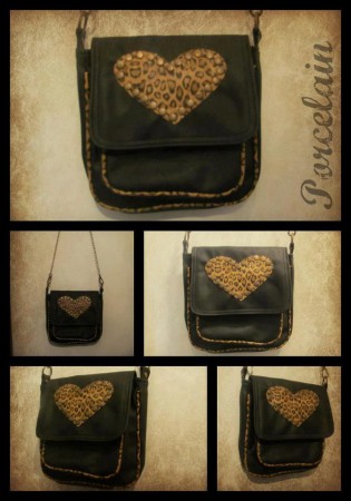 Art. 1036 cartera con bolsillo externo color Negro y Animal Print $210